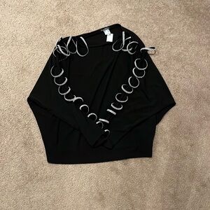 It’s a woman’s blouse color black and white with gems